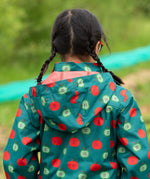 Close up of the hood on the Little Green Radicals apple picking recycled waterproof children's raincoat with a child wearing it. The hood is lined with a dark red mesh.