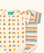 Close up of the Little Green Radicals vintage style cream rainbows organic cotton short sleeved baby bodysuit 2 Pack. One vest with a repeat nature themed print and one with a cream rainbow striped design. 