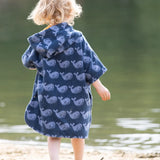 Back of child wearing the Little Green Radicals blue organic cotton Singing Whales Baby Towel Poncho.
