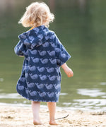 Back of child wearing the Little Green Radicals blue organic cotton Singing Whales Baby Towel Poncho.