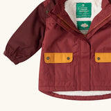 Close up of the pockets on the front of the Little Green Radicals berry purple recycled waterproof fleece lined winter coat.