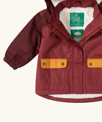 Close up of the pockets on the front of the Little Green Radicals berry purple recycled waterproof fleece lined winter coat.