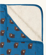 Close up of the Little Green Radicals bears organic sherpa hooded baby blanket showing the fluffy fleece lining. Blue hooded blanket with brown bears print.