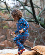 Child wearing Little Green Radicals  blue bears organic cotton pyjamas and striped socks. 