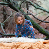Child wearing Little Green Radicals  long sleeved blue bears organic cotton pyjamas.