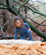 Child wearing Little Green Radicals  long sleeved blue bears organic cotton pyjamas.