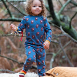 Child wearing Little Green Radicals  blue bears organic cotton pyjamas and striped socks. 