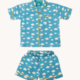 Little Green Radicals Blue Clouds Button Through Pyjama Short Set. The set contains a traditional style, short sleeved shirt style top with matching shorts. The print has a blue background with an over white cloud print. Little green Radicals have a wide range of organic cotton, Fairtrade children's clothing and outerwear available here at Babipur.