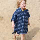 Child wearing the Little Green Radicals clue singing whale kids organic cotton towel poncho. 
