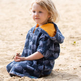 Child wearing the Little Green Radicals clue singing whale kids organic cotton towel poncho. 