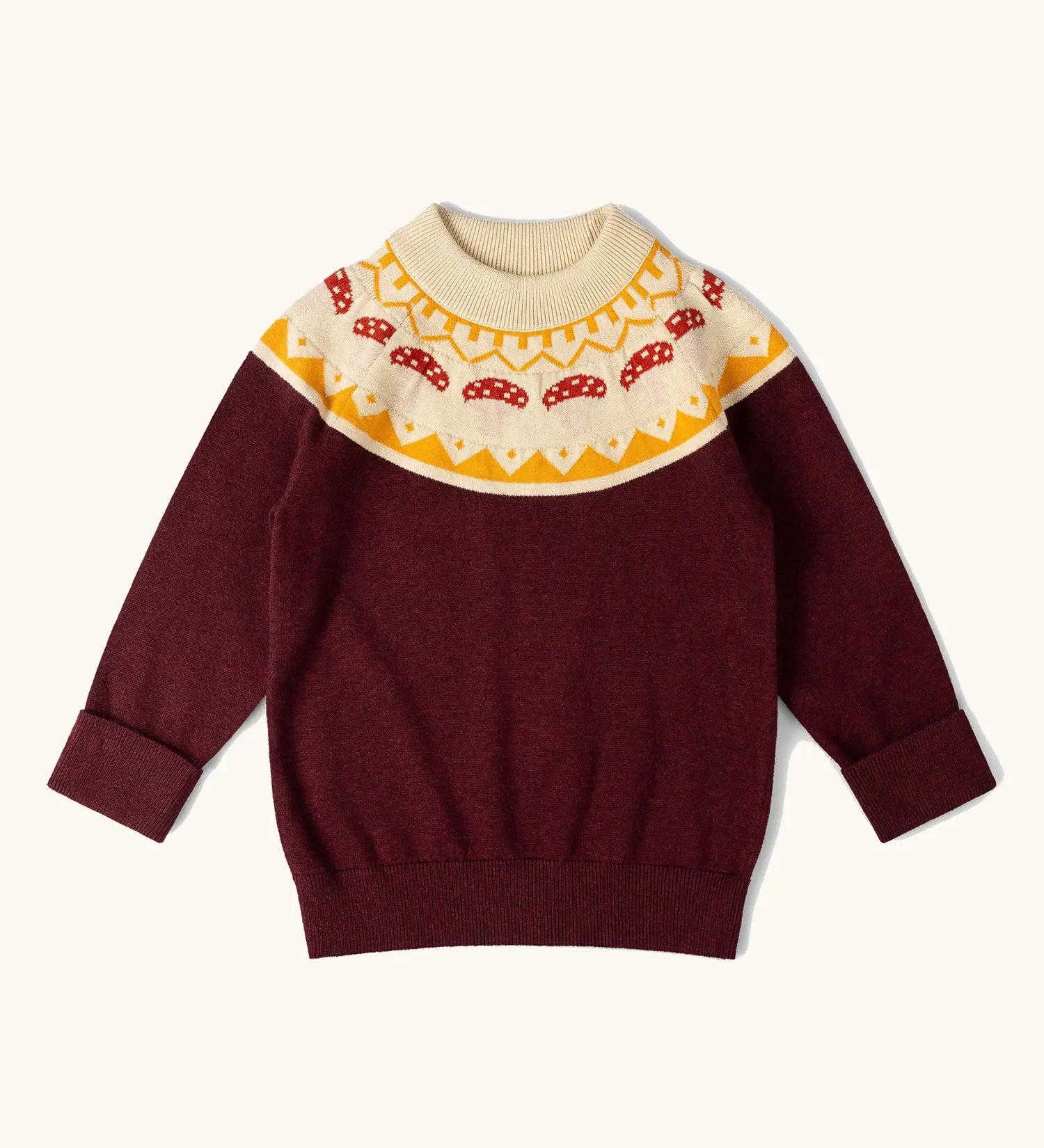 Little Green Radicals knitted organic cotton jumper with a mushroom Fair Isle. Brown jumper with mushroom air isle design around the neckline.