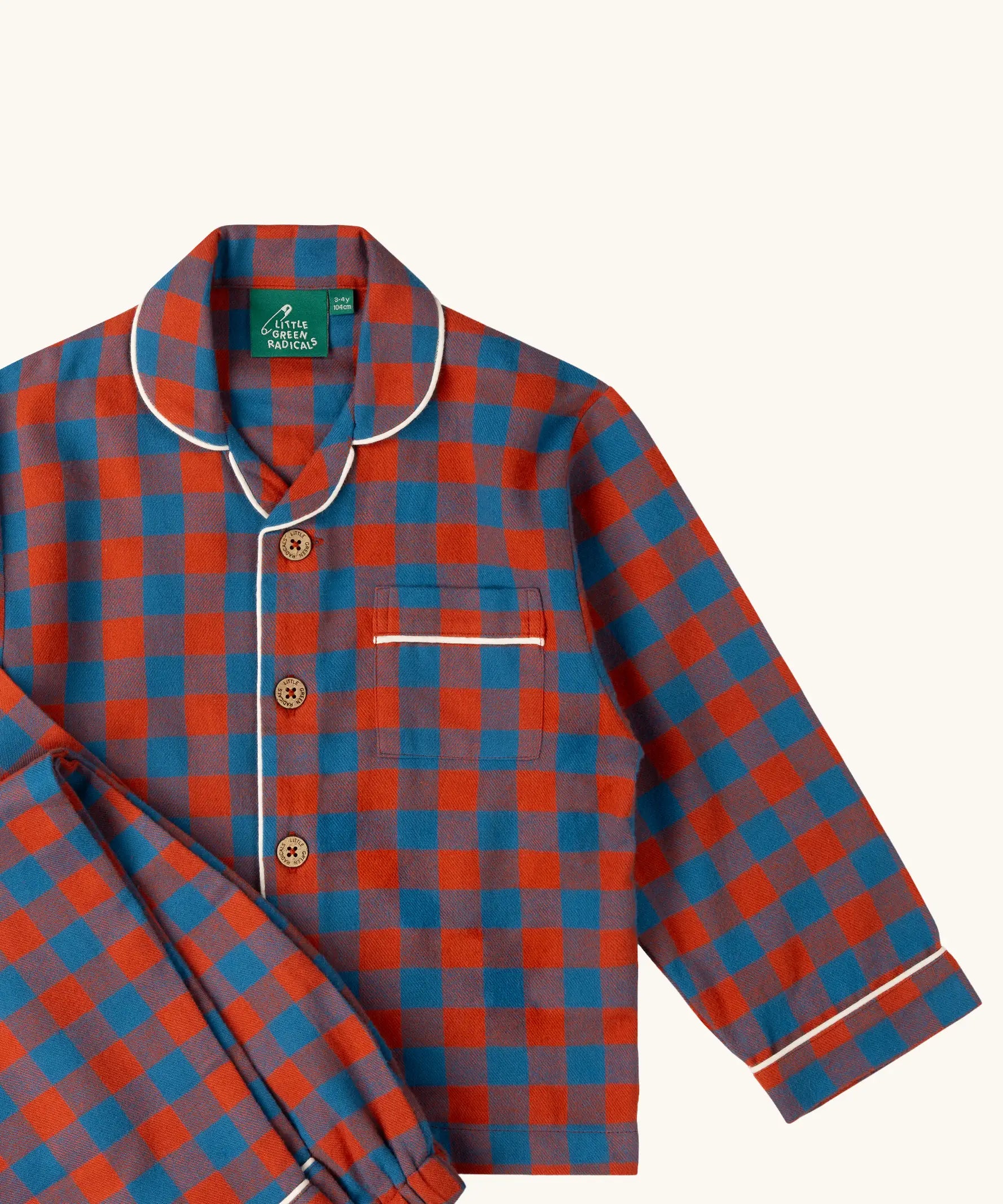 Close up of the Little Green Radicals burnt ochre and blue check classic children's pyjamas.