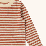 Close up of the Little Green Radicals burnt ochre stripe organic cotton long sleeve organic cotton children's top.
