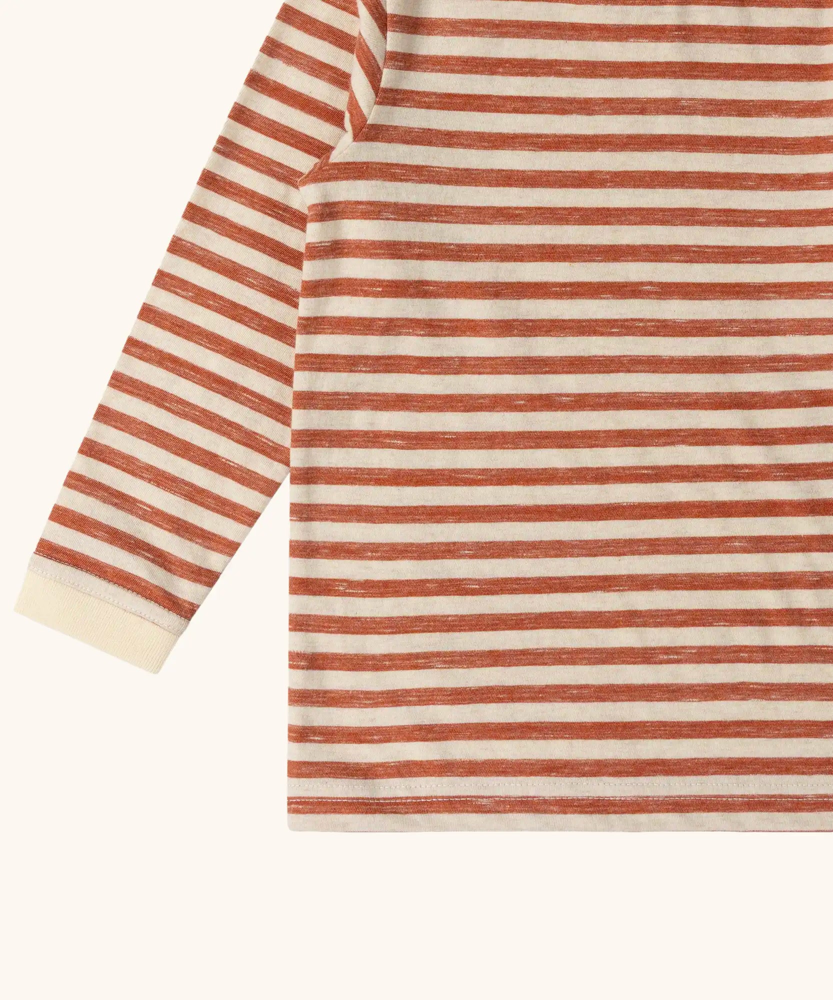 Close up of the Little Green Radicals burnt ochre stripe organic cotton long sleeve organic cotton children's top.