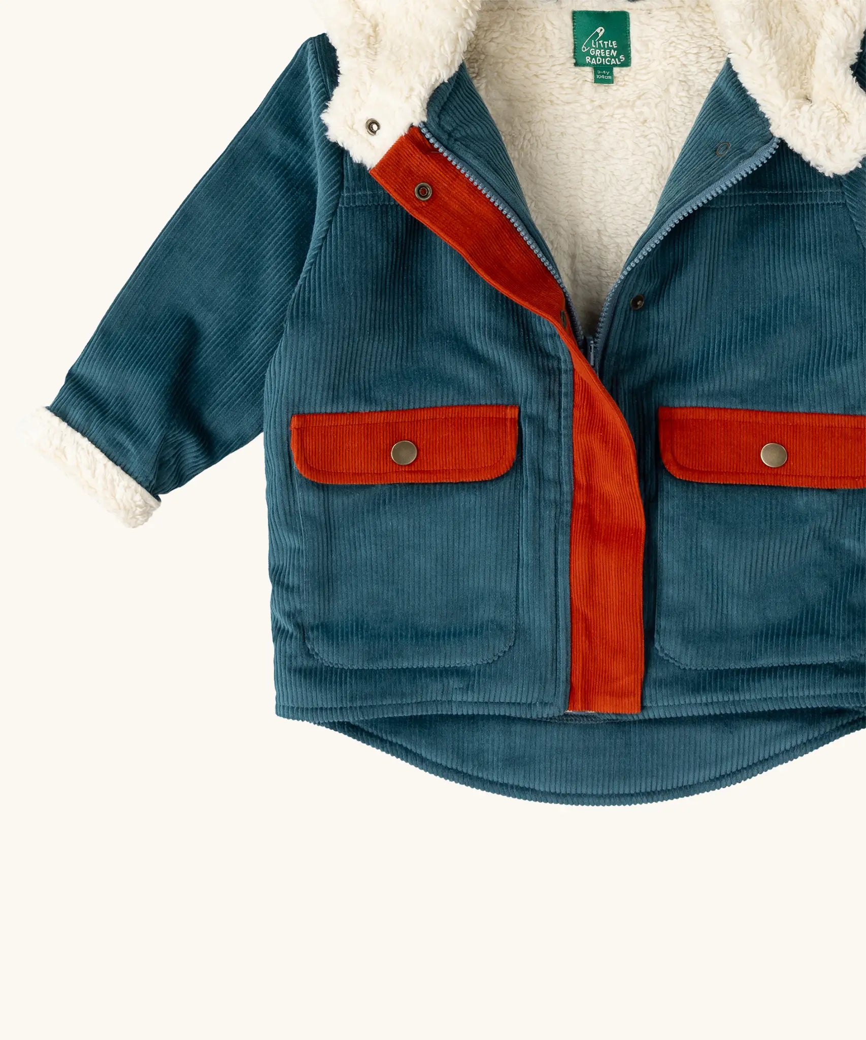 Close up of the pockets on the front of the Little Green Radicals calm sea colourblock organic cotton sherpa fleece lined toasty coat.