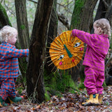 Child wearing the Little Green Radicals berry pink check classic pyjamas with another child wearing another colour way.