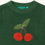 Close up of the cherry embroidered on the front of the Little Green Radicals kids dark green knitted sleeveless pullover.