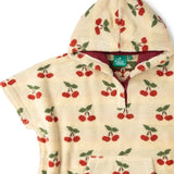 Close up of the red lined hood on the Little Green Radicals little cherries cream organic cotton kids hooded towel poncho.The poncho has a popper closure on the neck and a kangaroo pocket on the front. 