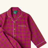 Close up of the Little Green Radicals Kids berry pink check organic cotton classic pyjamas. Button up long sleeve top and matching trousers. 