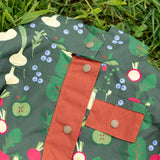 Dark gold coloured buttons on the front of the Little Green Radicals feast waterproof recycled kids raincoat.