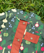 Dark gold coloured buttons on the front of the Little Green Radicals feast waterproof recycled kids raincoat.
