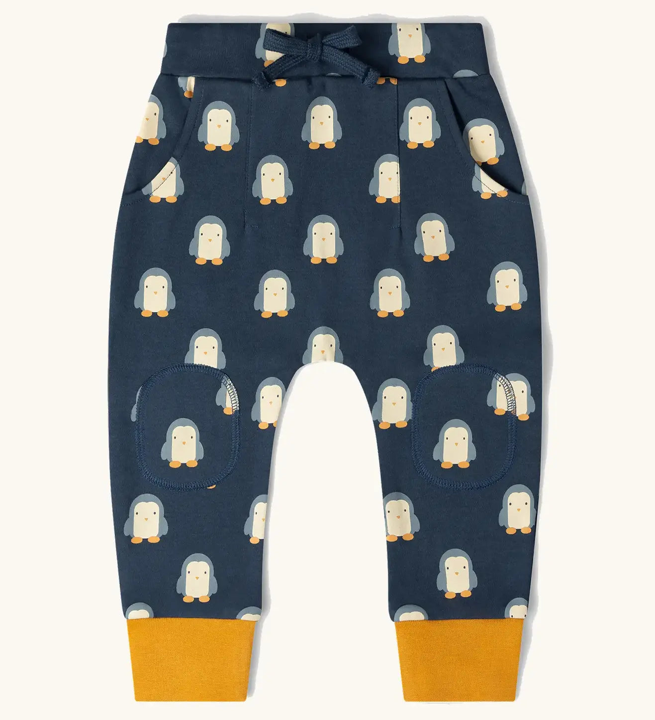 Little Green Radicals organic cotton comfy joggers with a blue penguins design and yellow leg cuffs.