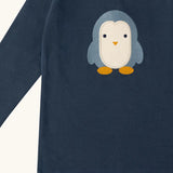 Close up of the Little Green Radicals blue penguins applique long sleeve organic cotton top in navy.