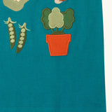Close up of the hemline on the Little Green Radicals kids Spring garden embroidered organic cotton green t-shirt. 