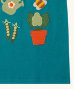 Close up of the hemline on the Little Green Radicals kids Spring garden embroidered organic cotton green t-shirt. 