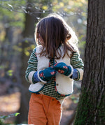 A child wearing the Little Green Radicals Children's Sherpa Fleece Gilet in the red foxes design. This gilet is a part of a wide range of organic cotton clothing for children available here at Babipur. 