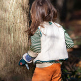 A child wearing the Little Green Radicals Children's Sherpa Fleece Gilet in the red foxes design. This gilet is a part of a wide range of organic cotton clothing for children available here at Babipur. 