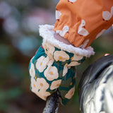 A close up of the Little Green Radicals Hedgerow print Children's Sherpa Lined Mittens on a child's hand. 