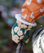 A close up of the Little Green Radicals Hedgerow print Children's Sherpa Lined Mittens on a child's hand. 