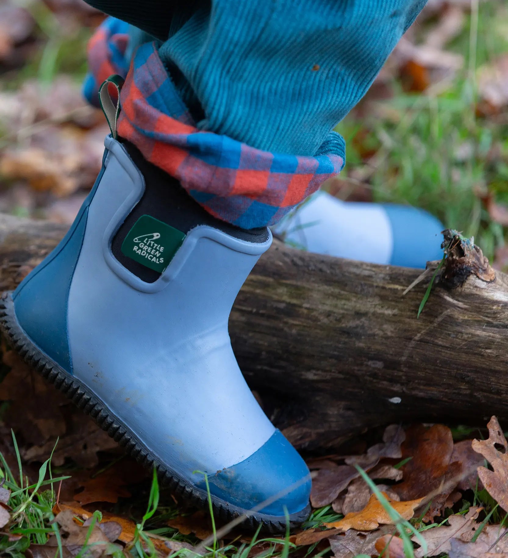 Close up of child wearing the Little Green Radicals soft blue natural rubber ankle rain wellington boots.