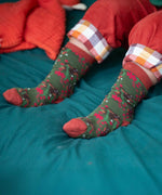 A close up of the winter rabbits design socks on a child's feet. Little Green Radicals Ankle Socks 3 Pack - Winter Rabbits. The organic cotton children's socks are a part of a wide range of organic cotton clothing for children available here at Babipur. 