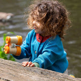 A child wearing the Little Green Radicals From One To Another Deep Blue Colour Block Knitted Cardigan. This organic cotton cardigan is part of a wide range of organic cotton, Fairtrade children's clothing and outerwear available here at Babipur.