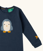 Close up of the Little Green Radicals blue penguins applique long sleeve organic cotton top in navy.
