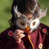 Close up of a child wearing the Little Green Radicals organic cotton snuggly knitted cardigan with a berry petal design. Dark purple cardigan with pink flowers details.