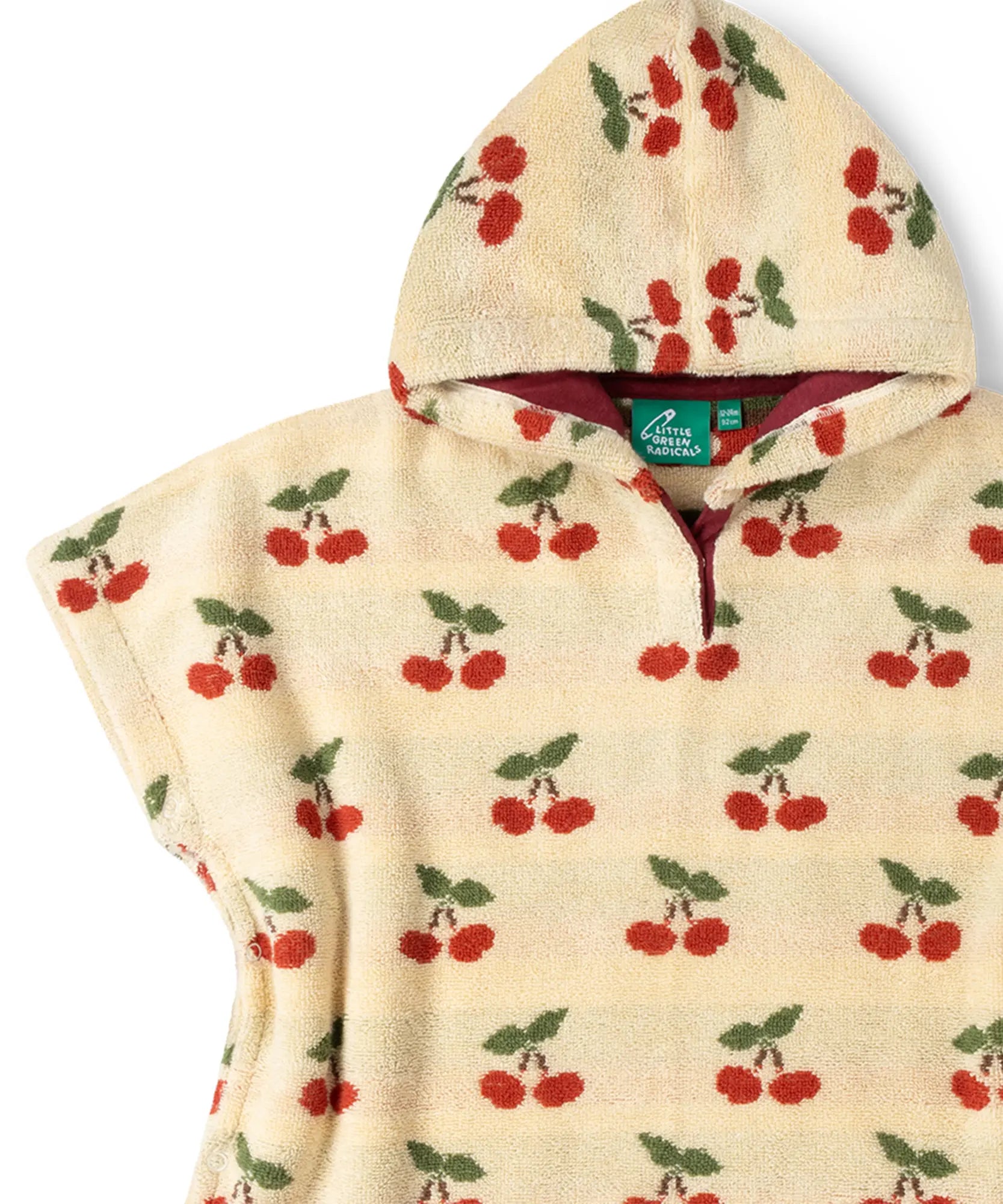 Red lined hood on the Little Green Radicals little cherries organic cotton baby towel poncho.