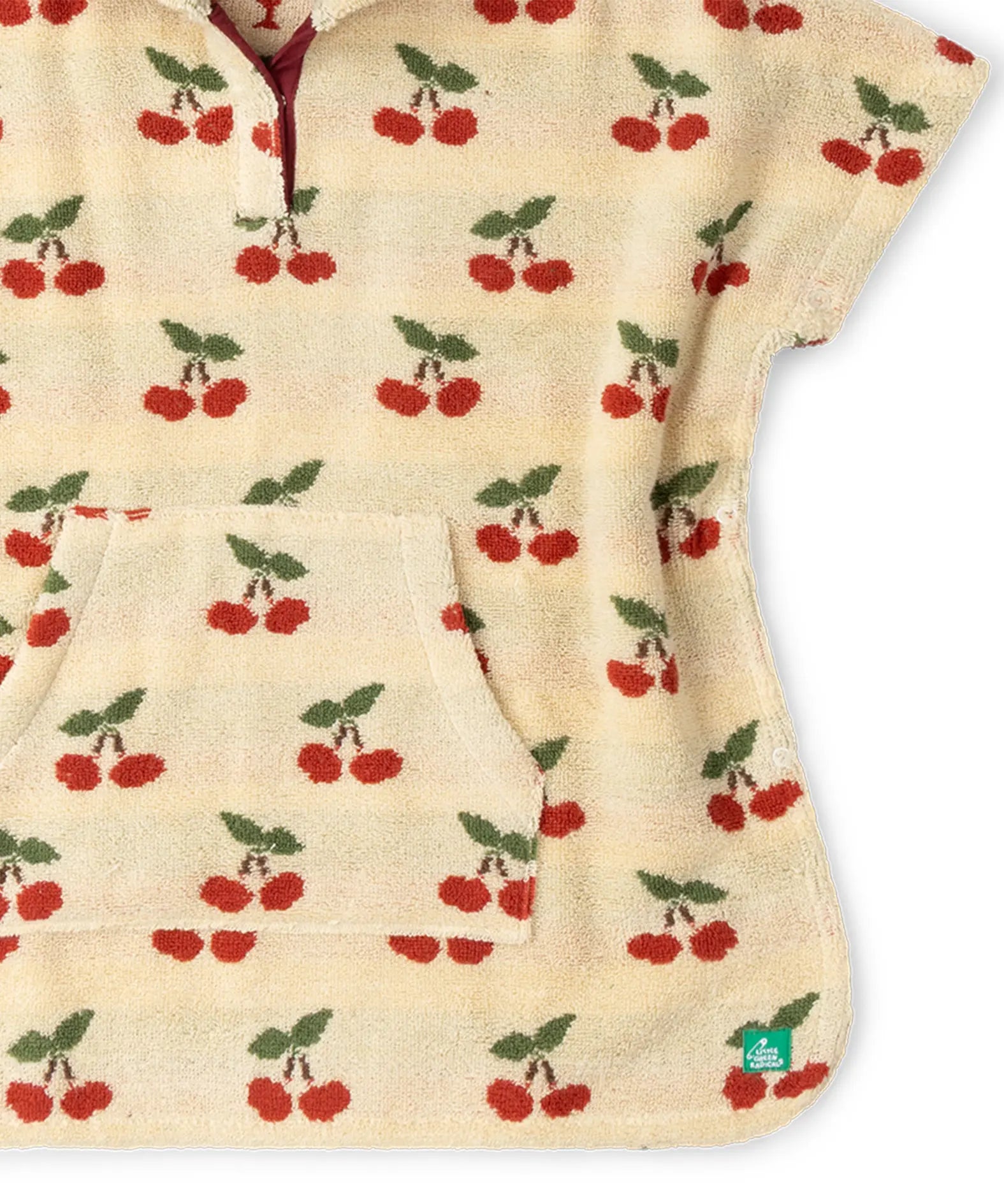 kangaroo pocket on the front of the Little Green Radicals little cherries cream organic cotton kids hooded towel poncho.The poncho has a popper closure on the neck and a kangaroo pocket on the front. 