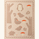 Little Green Radicals cream folk tales knitted organic cotton baby blanket with animals, trees and mushrooms.