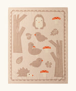 Little Green Radicals cream folk tales knitted organic cotton baby blanket with animals, trees and mushrooms.