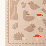 Close up of the Little Green Radicals cream folk tales knitted organic cotton baby blanket