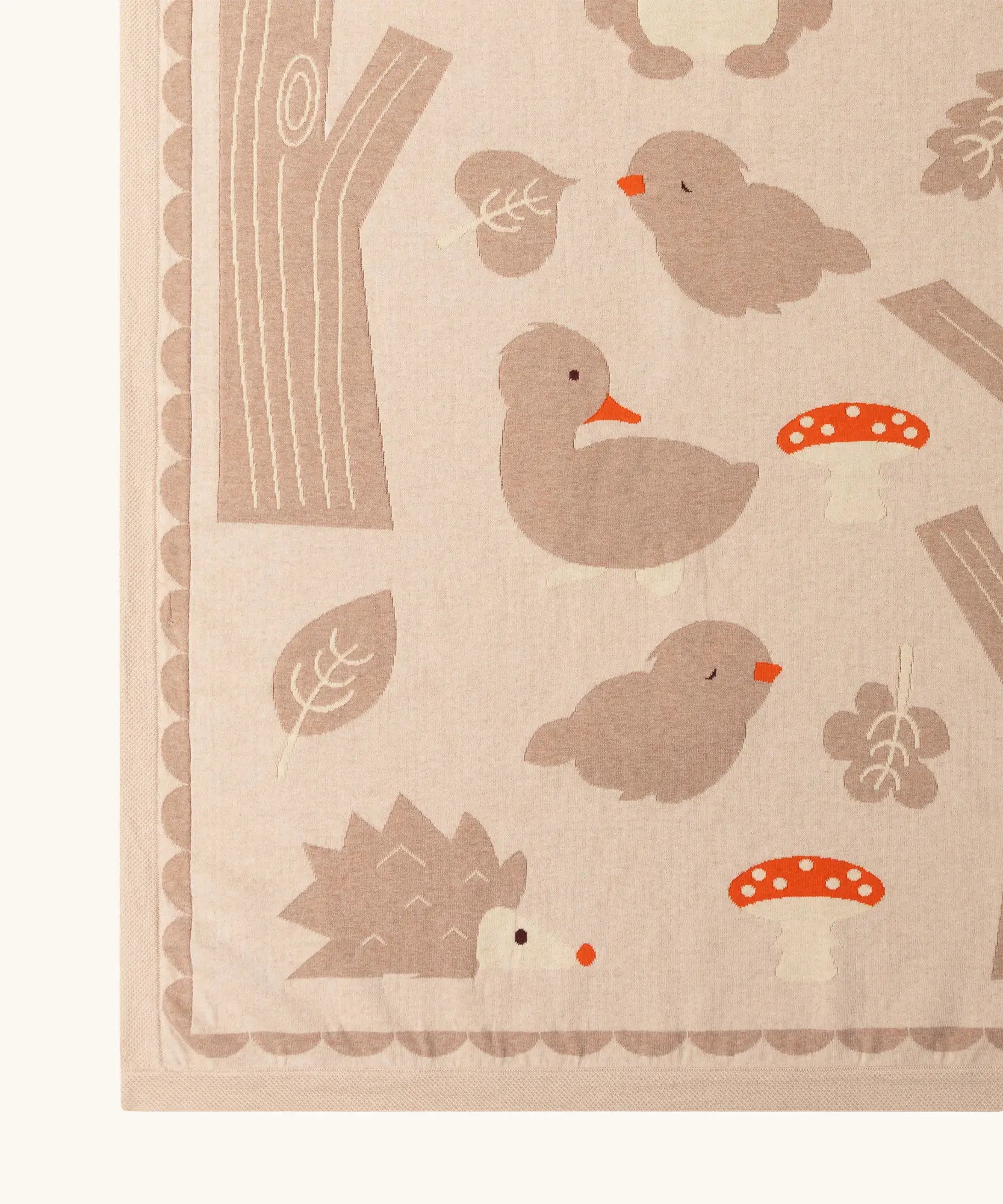Close up of the Little Green Radicals cream folk tales knitted organic cotton baby blanket