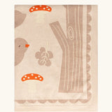 Little Green Radicals cream folk tales knitted organic cotton baby blanket shown folded.