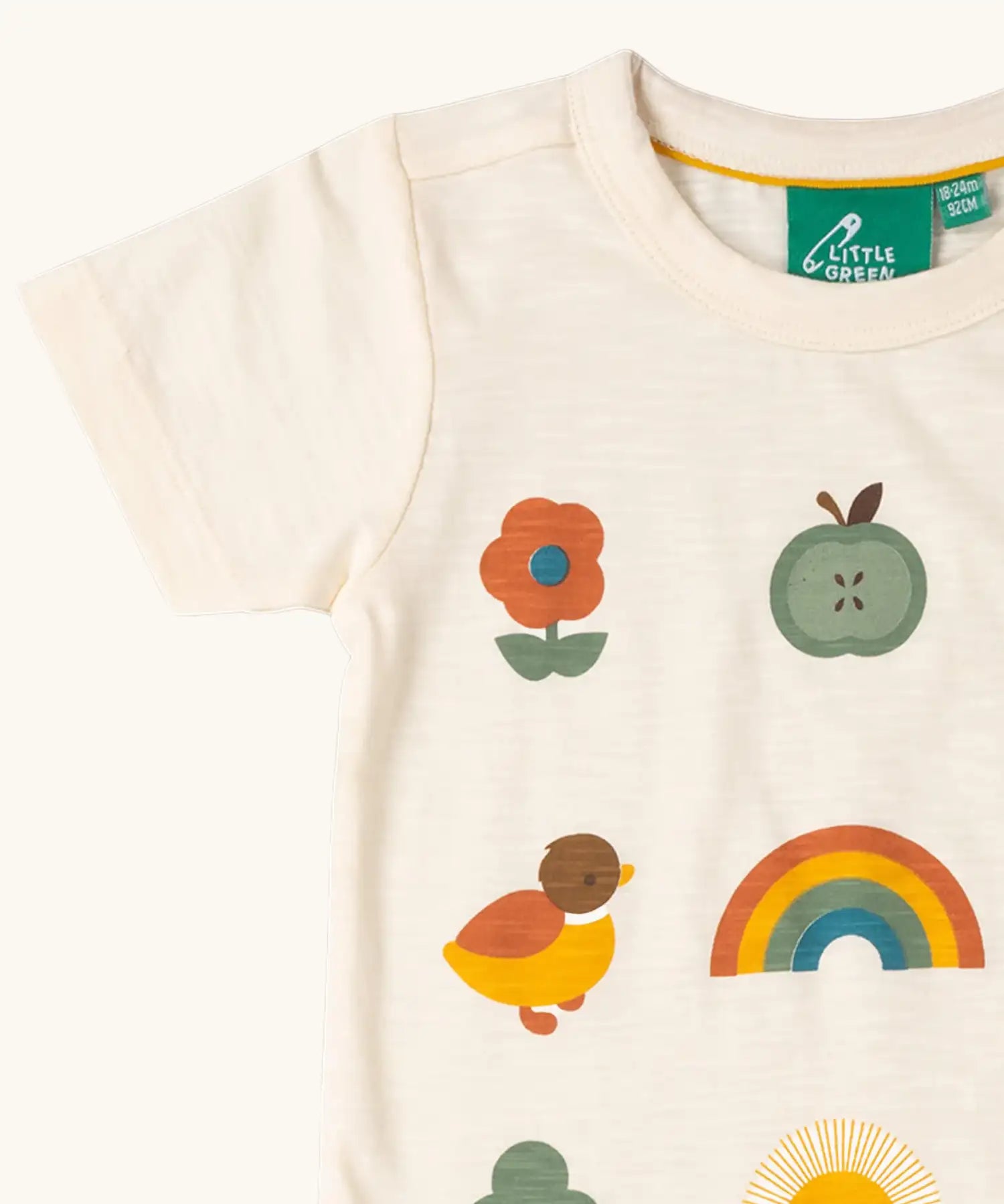 Close up of the Little Green Radicals cream vintage style kids organic cotton t-shirt showing the printed details on the front.