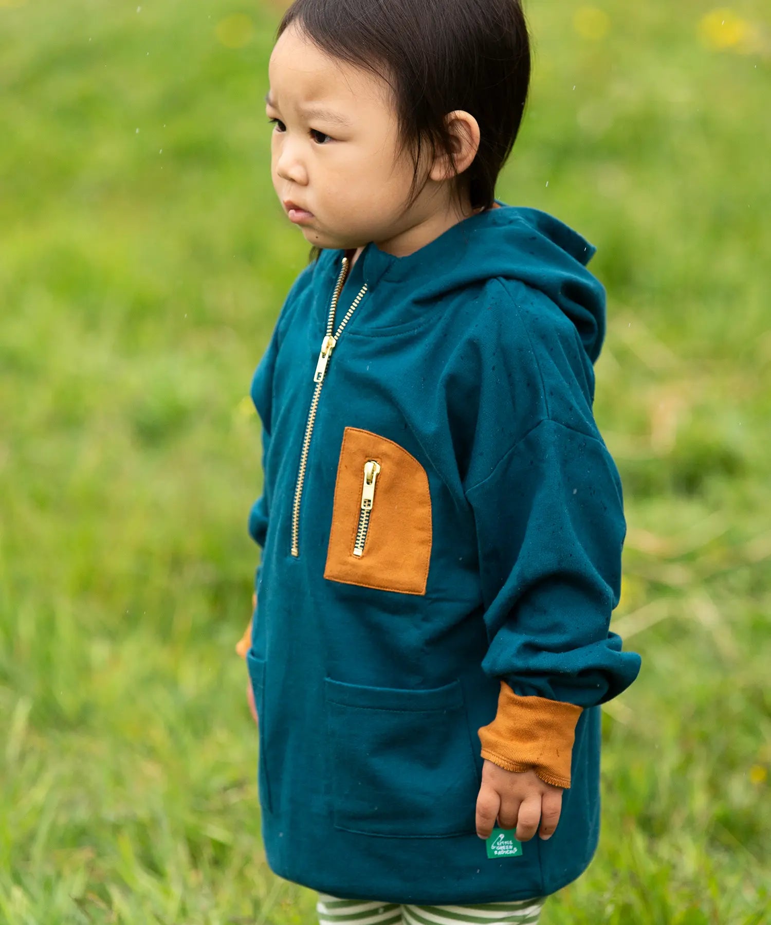 Child wearing a Little Green Radicals children's atlantic deep blue organic cotton quarter zip hoodie.