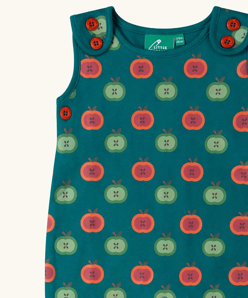 Close up of the red and green repeat apple print on the Little Green Radicals apple picking everyday organic cotton dungarees.
