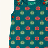 Close up of the red and green repeat apple print on the Little Green Radicals apple picking everyday organic cotton dungarees.
