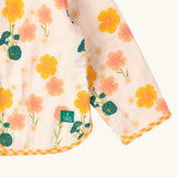 Close up of the Little Green Radicals children's Flora Reversible Spring Jacket with yellow gingham print binding on edges.